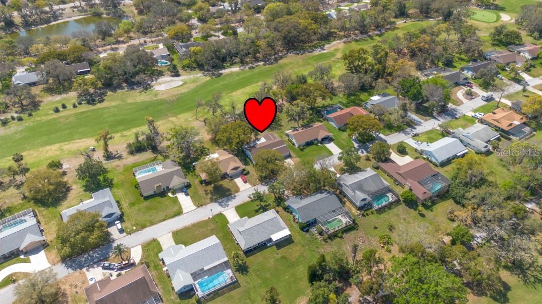 Flyover view of 2nd hole on beacon woods golf course and the backside of the home.