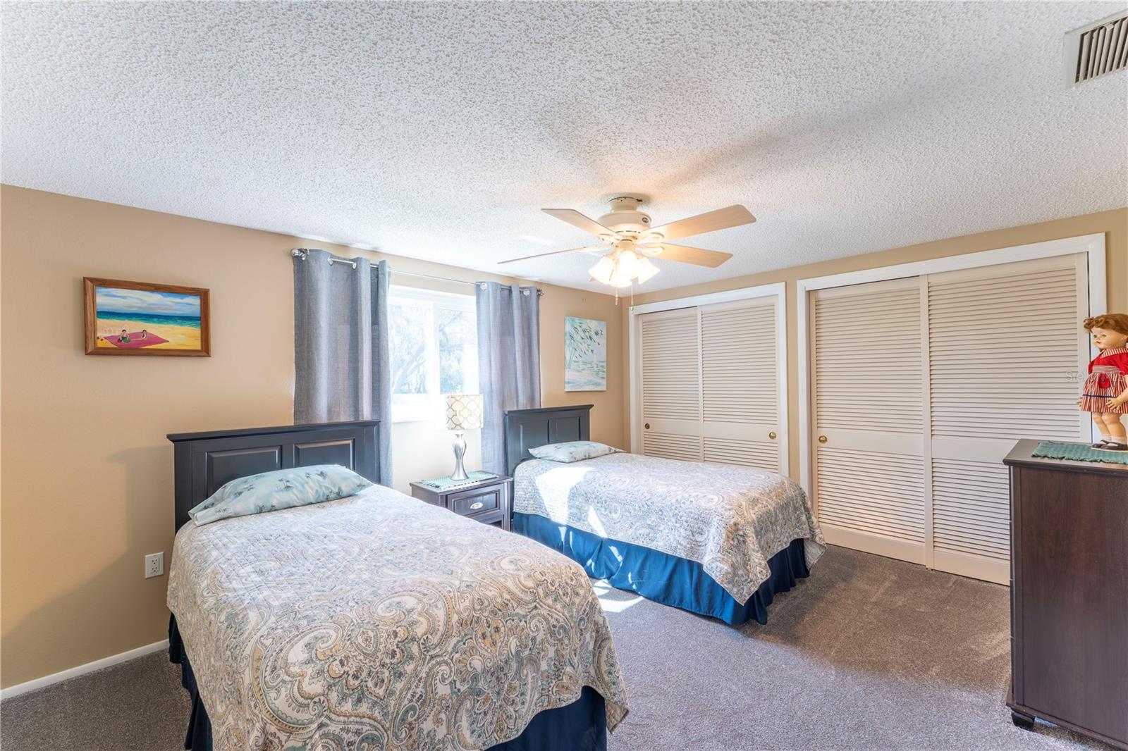 Large third bedroom with twin closets.