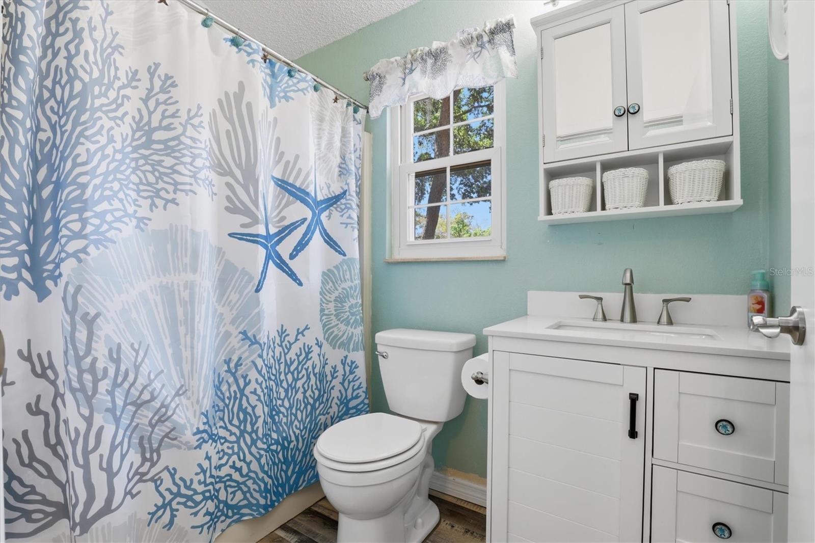 Well-appointed primary bathroom with a tub/shower combination.