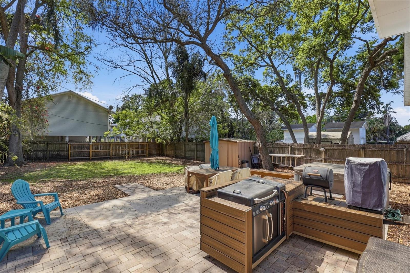 Built-in grill on the spacious pavered patio, ideal for gatherings and backyard meals.