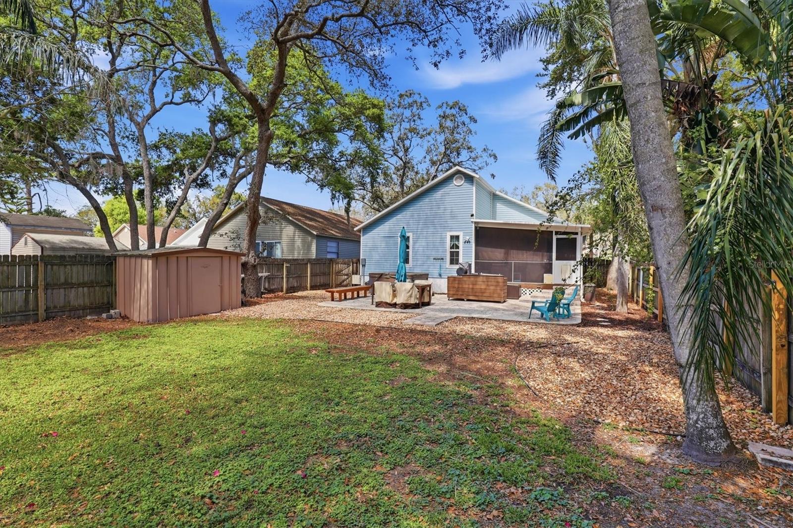Spacious backyard with a storage shed, perfect for tools or outdoor equipment.