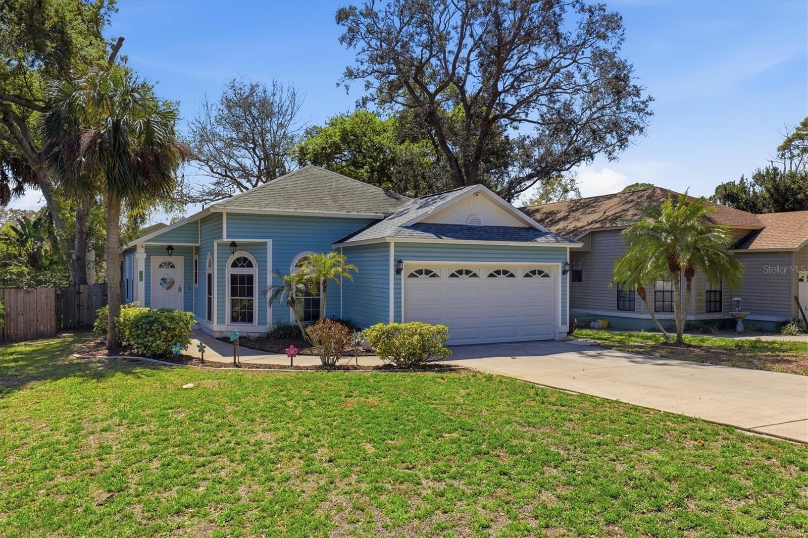 Charming front exterior with established landscaping, ample driveway parking, and a two-car garage.