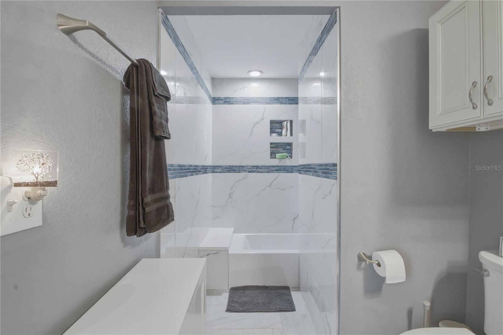 Seating area leads to the shower/tub combination.