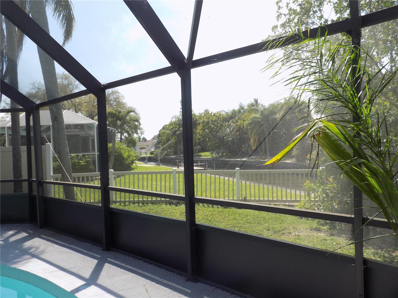 View of the canal from inside your screened in area