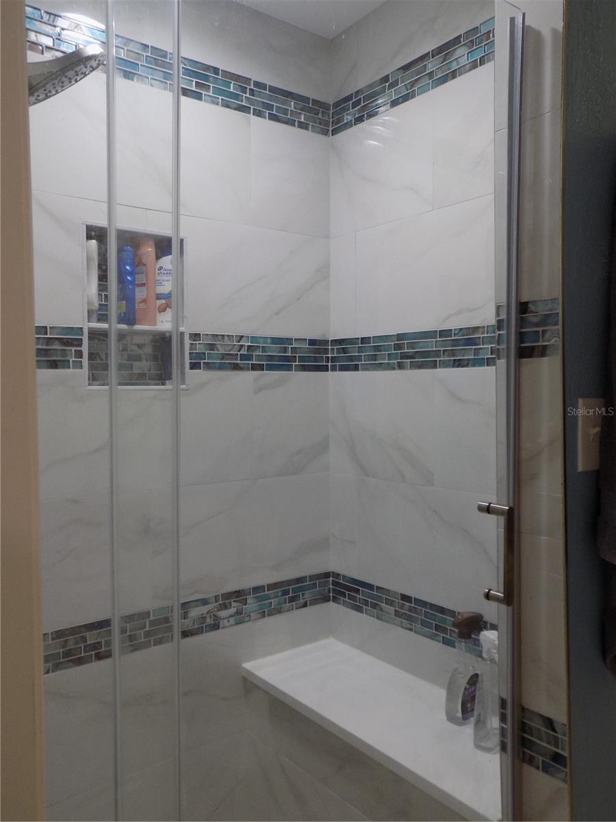 The shower with it's custom features includes a bench and insert area for your showering needs.
