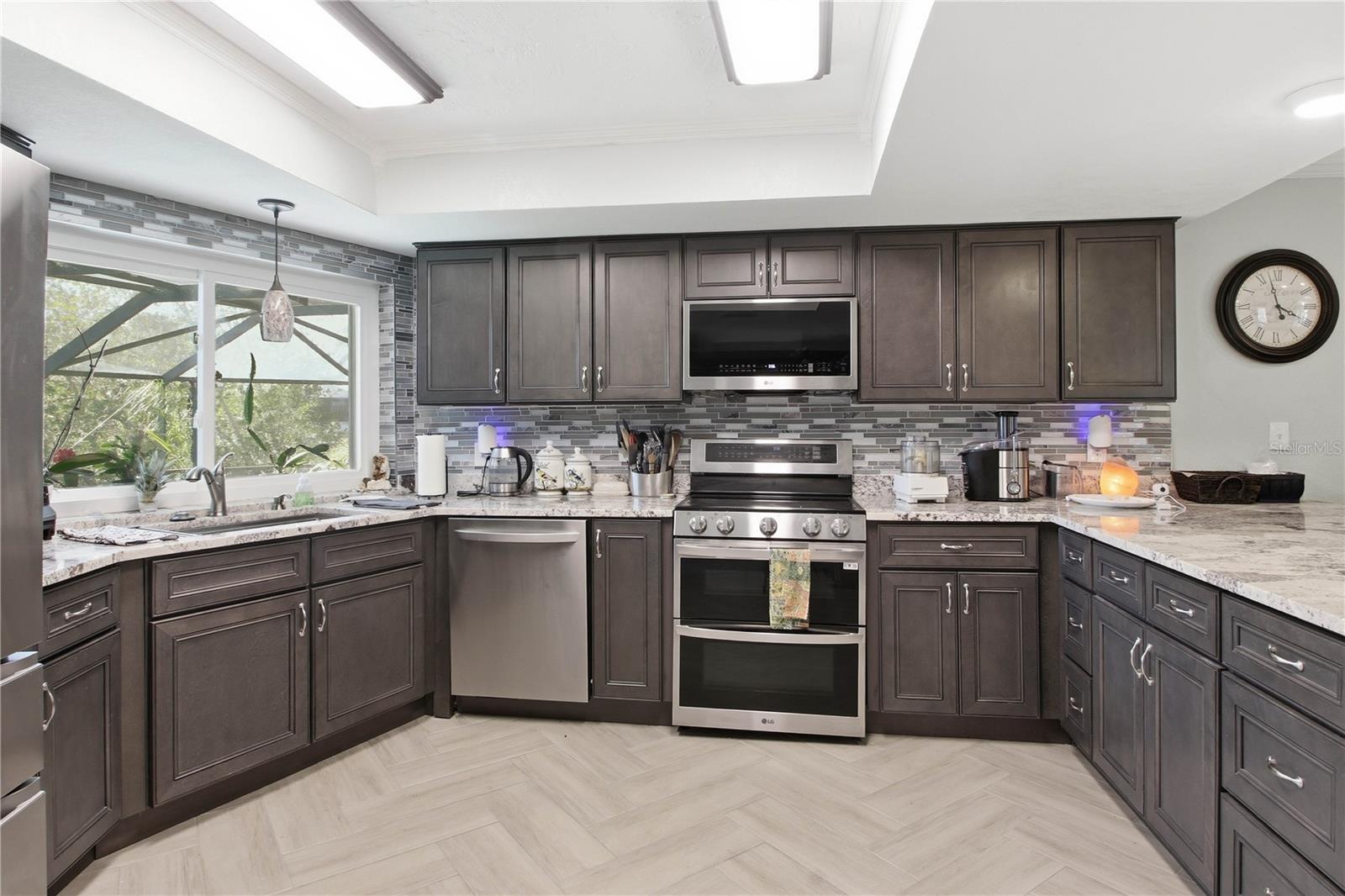 This totally renovated kitchen includes all new appliances, pull out shelving in the bottom storage, a hidden spice rack and a double stainless steel farm house sink.