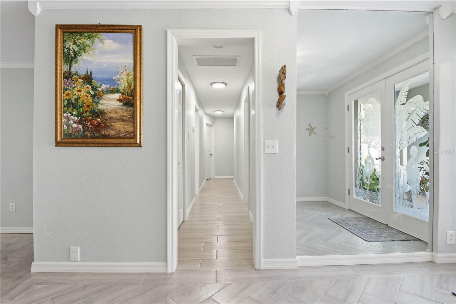 To the right of the front entrance is the hall that leads to the bedroom area. You will find multiple closets down this hall for more storage.