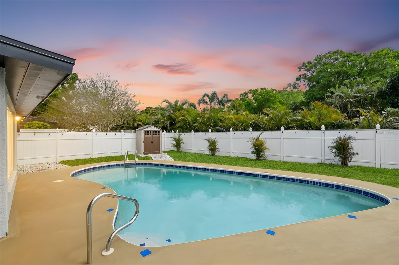 Private pool and fully fenced yard with new sod and landscaping.