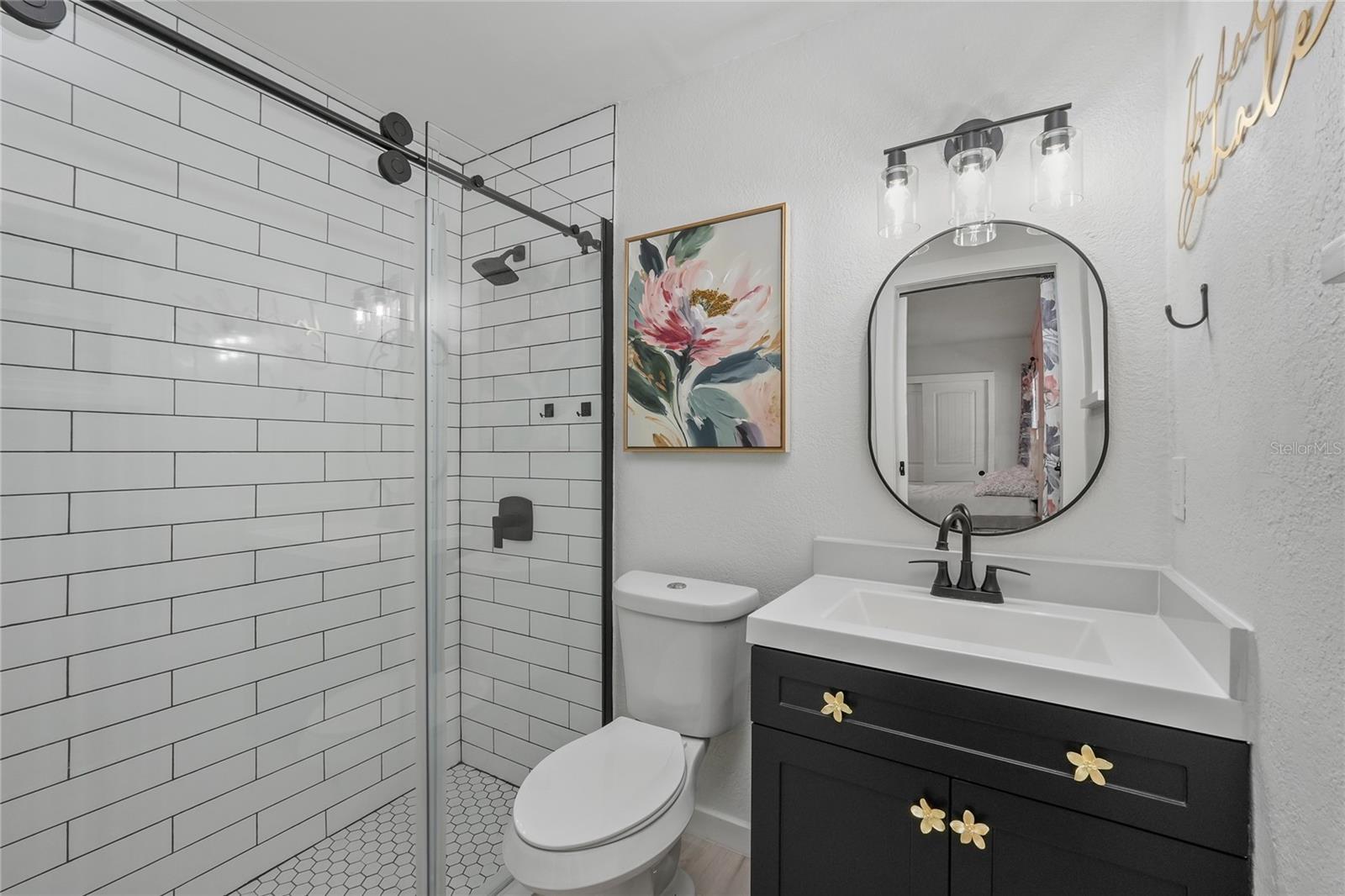 Updated bathrooms with tile and glass enclosures.