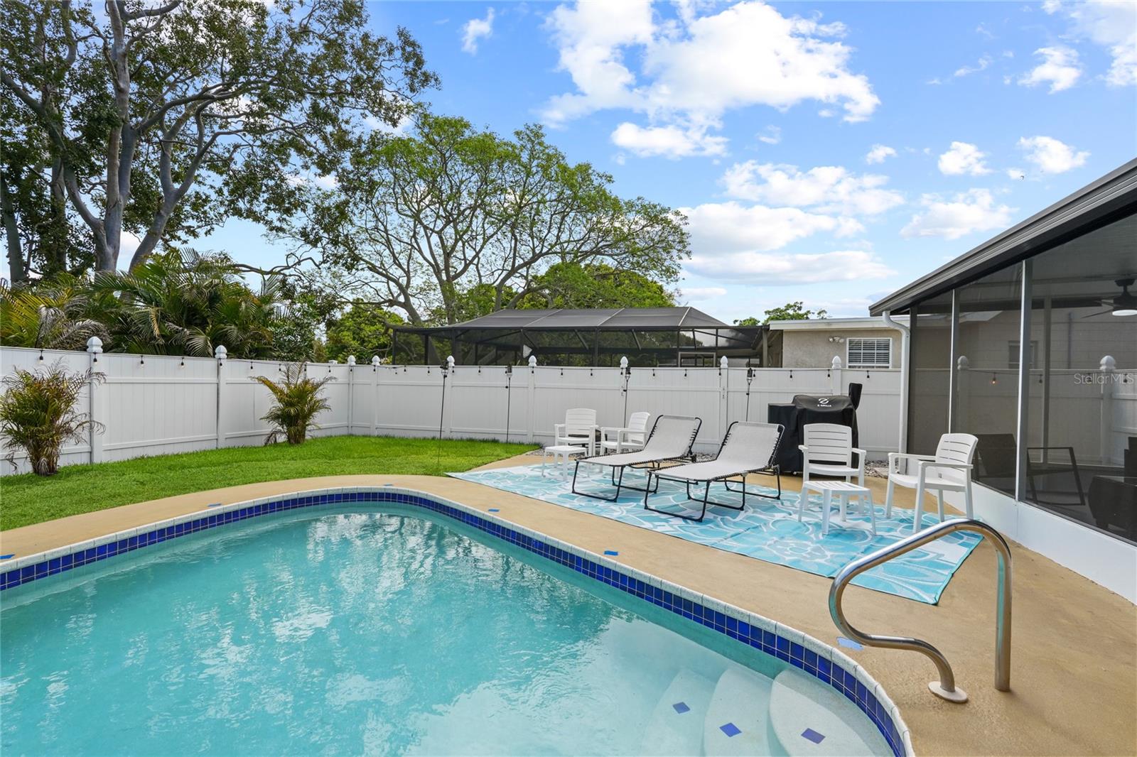Private pool and fully fenced yard with new sod and landscaping.