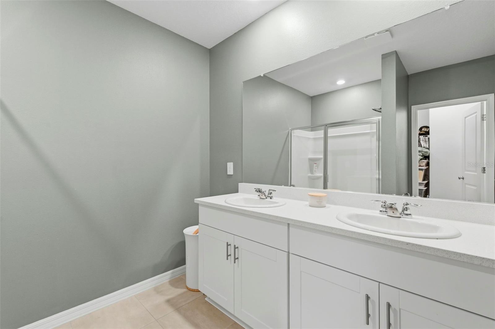 Primary bathroom has double sinks and a walk-in shower