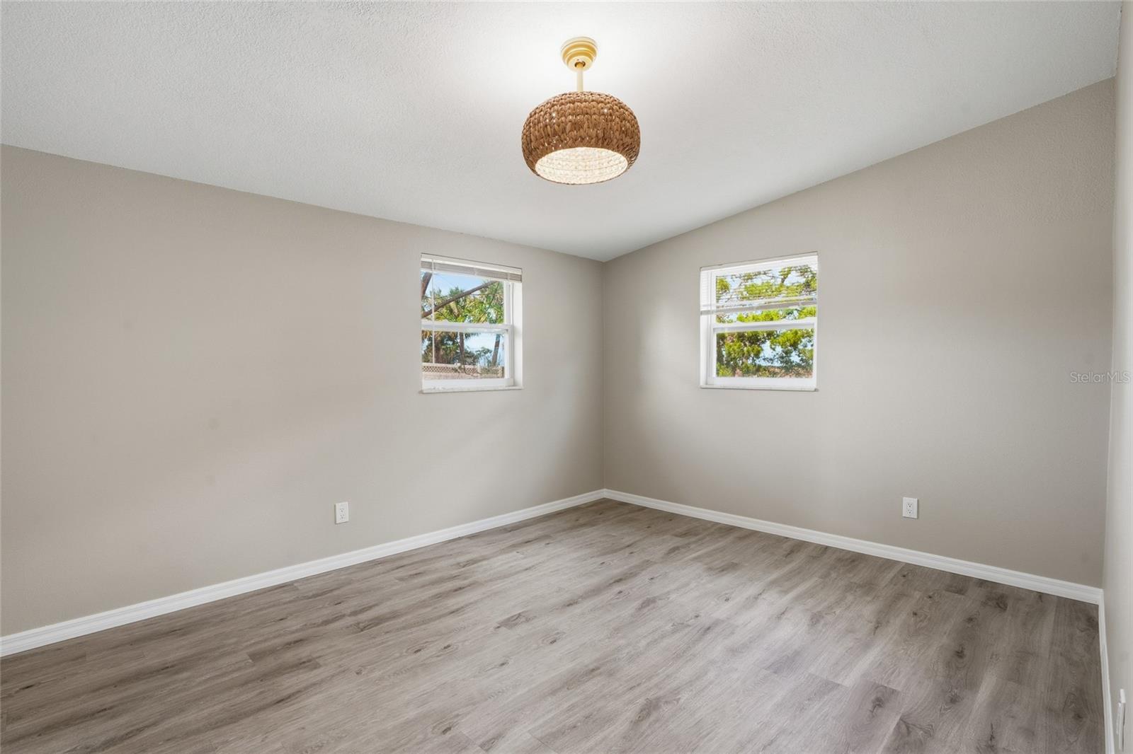 spacious bedrooms and modern light fixture with ceiling fan
