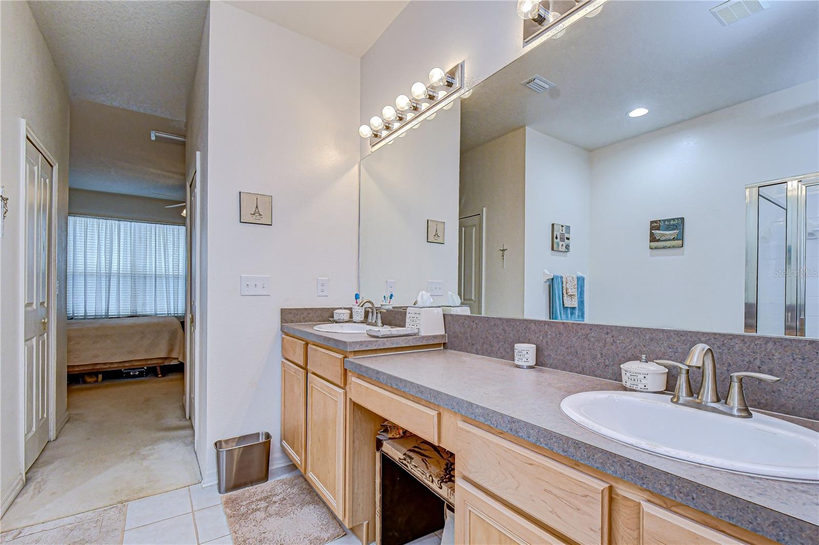 Dual sinks with a wide mirror allow for ample space to get ready for work or play!