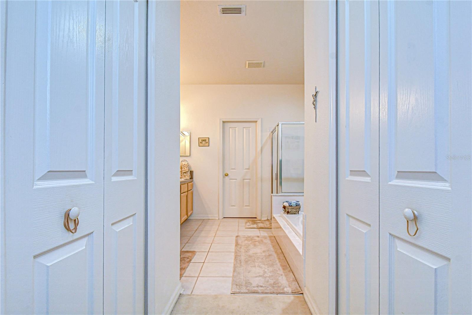 Two separate walk-in closets on each side as you enter the primary bathroom.