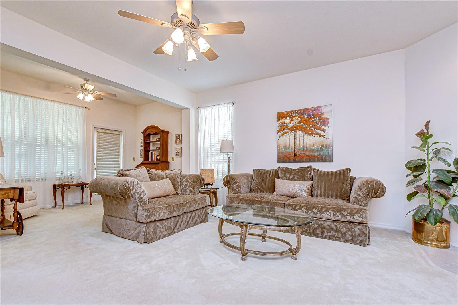 A large living area with adjoining reading or relaxing space.
