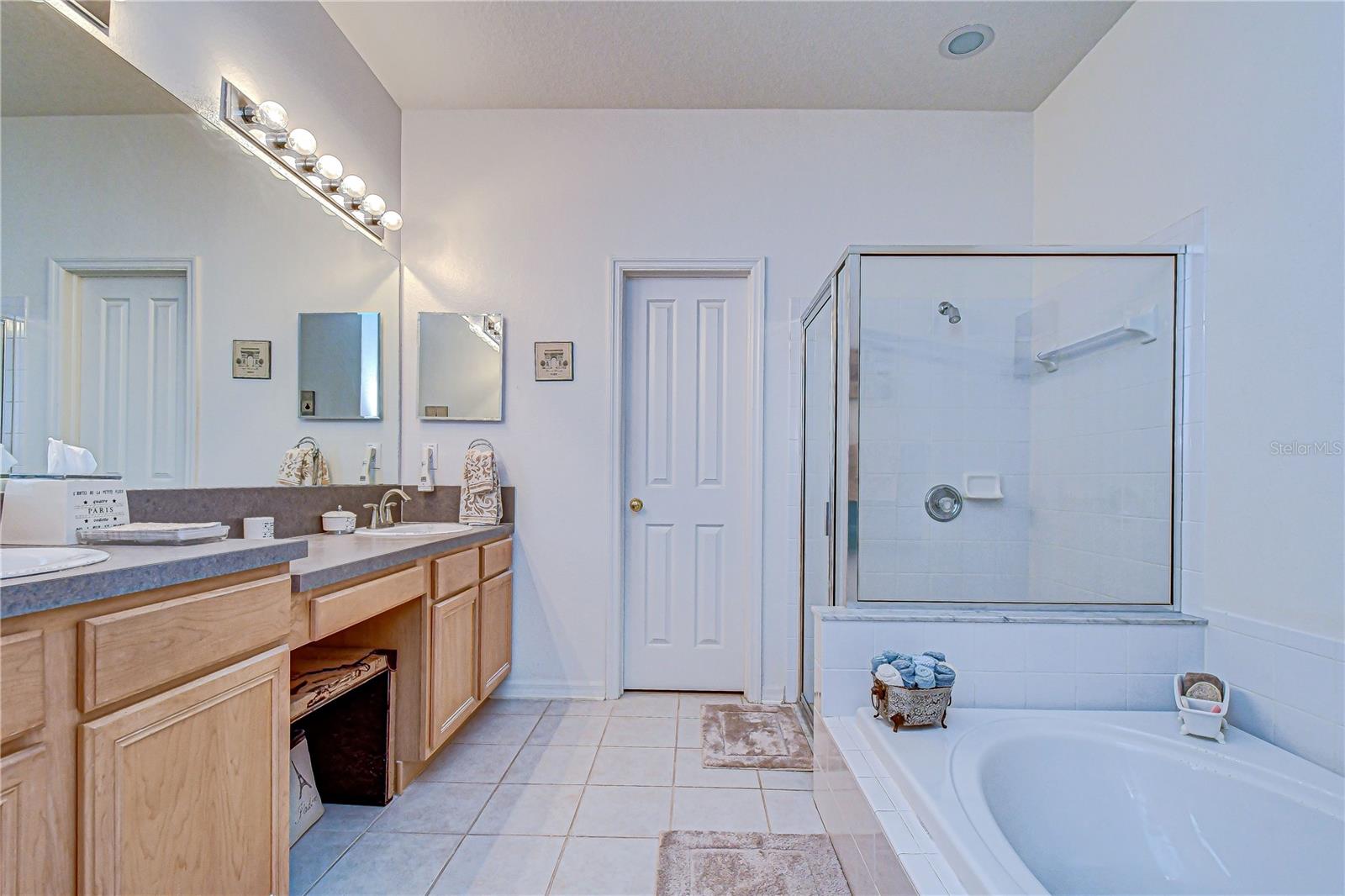 A soaking tub and separate shower encompass one side of the primary bathroom.