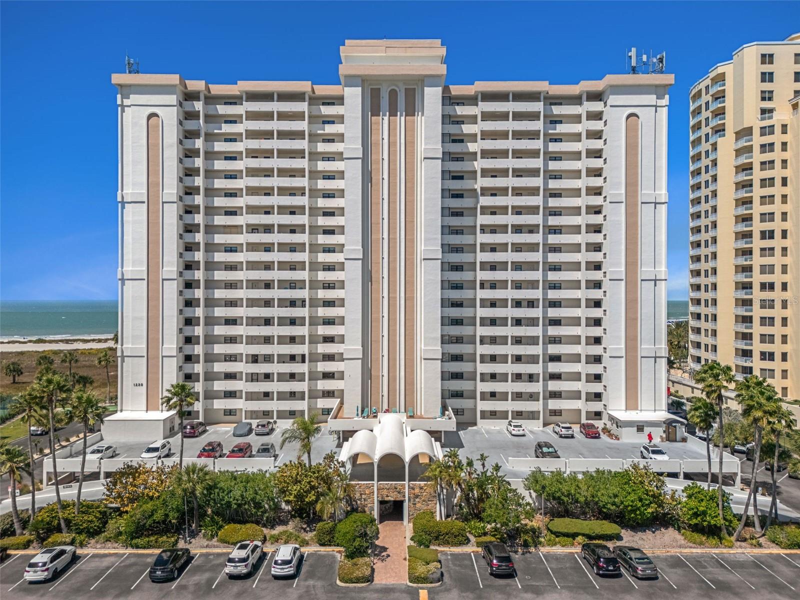 Landmark Tower One features a guarded gate ...Once in to parking area, access to the building is either through the lower lot & breezeway, the parking garage under building or the upper deck covered area.  Parking spot #124 in front to the left of lower level breezeway.