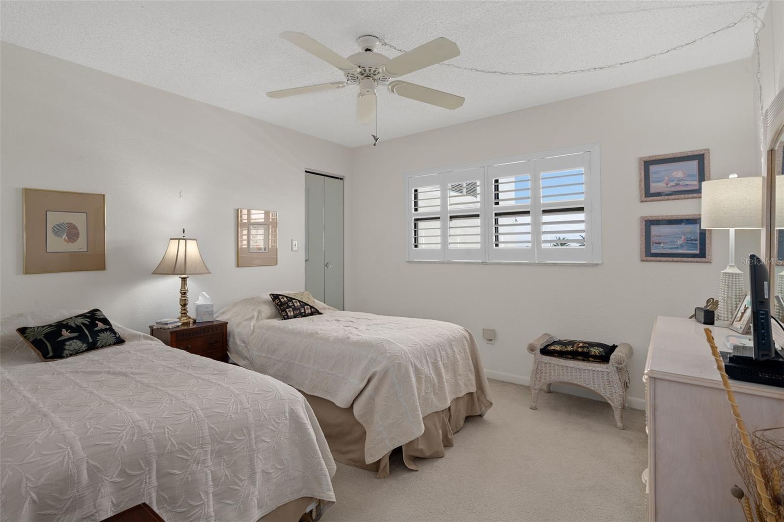 Bedroom 2 at front of unit also features a walk-in closet and Plantation shutters