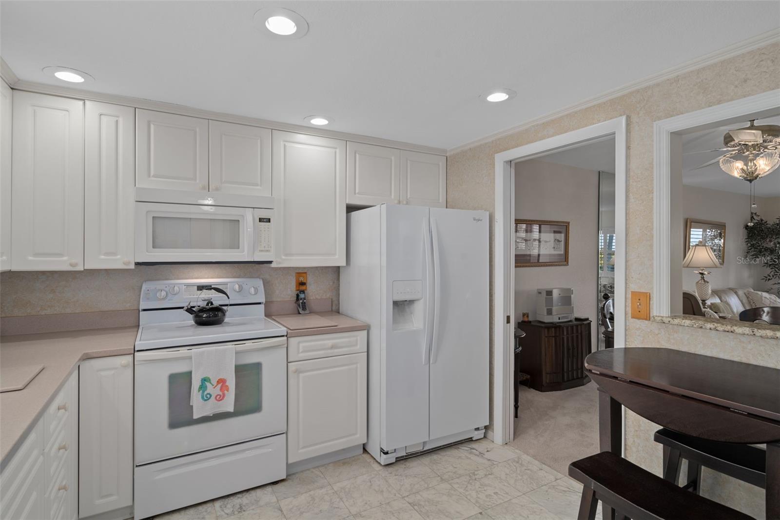 Eat-in Kitchen features a small table as well as a pass through to dining area