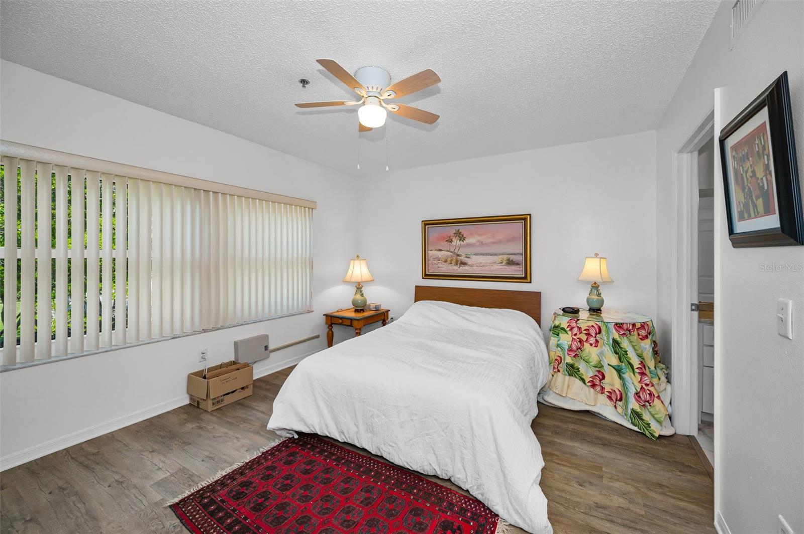 Primary bedroom with ensuite...open those blinds and enjoy the view!