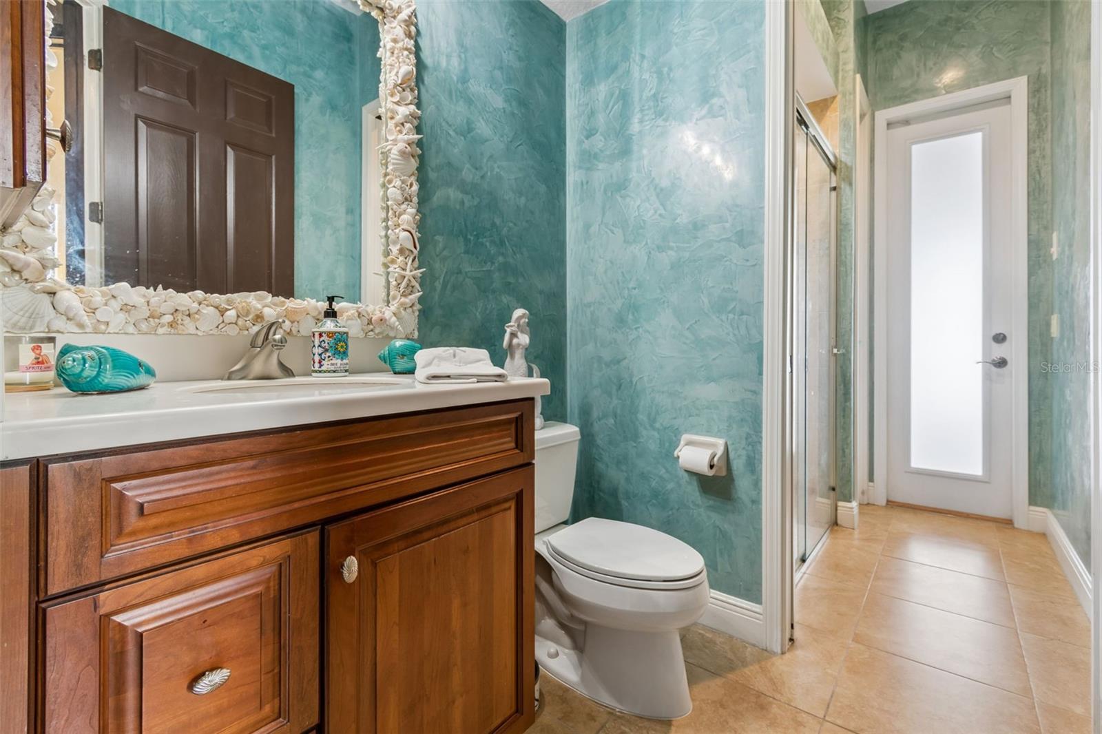 Pool Bath with Custom Shell Mirror and Polished, Venetian Plaster Walls