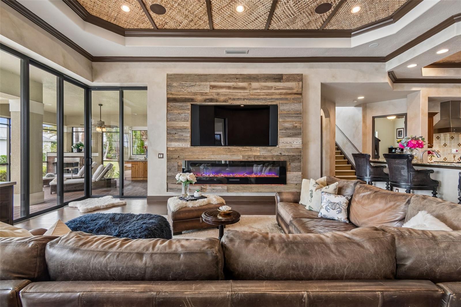 Custom built, distressed barnwood wall with 77" TV and LED fireplace