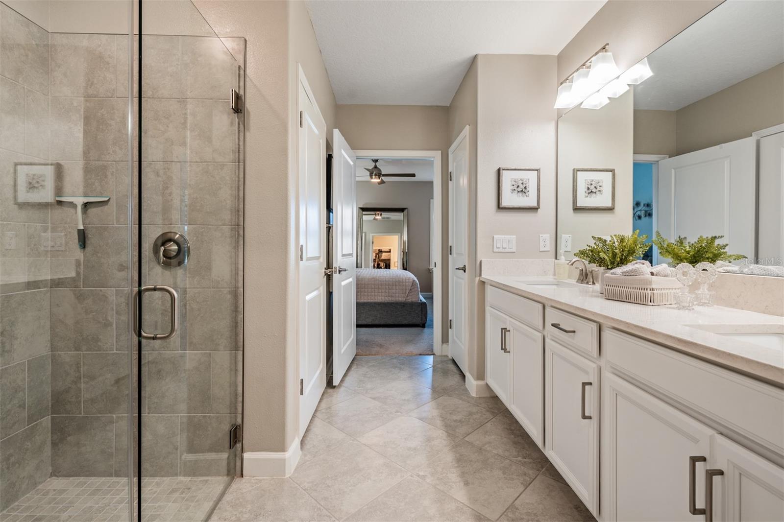 Bath ensuite with quartz tops, dual sinks, spacious shower and walk in closet