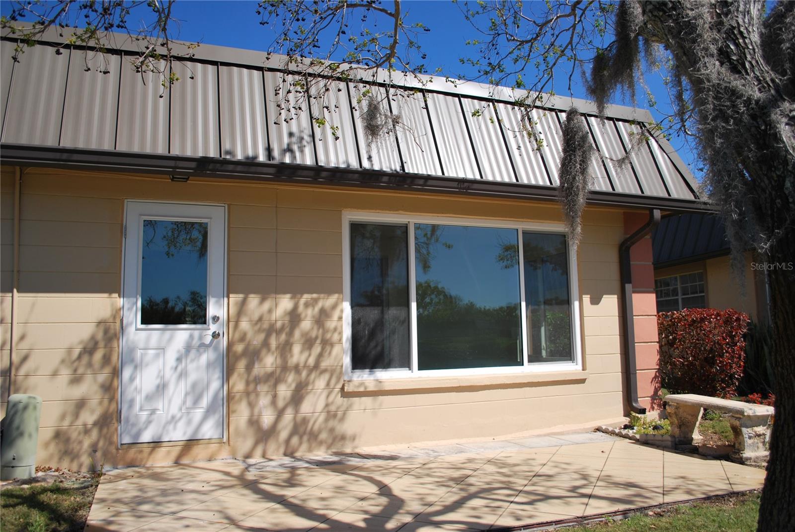 Backyard with large deck for relaxing, overlooking the water