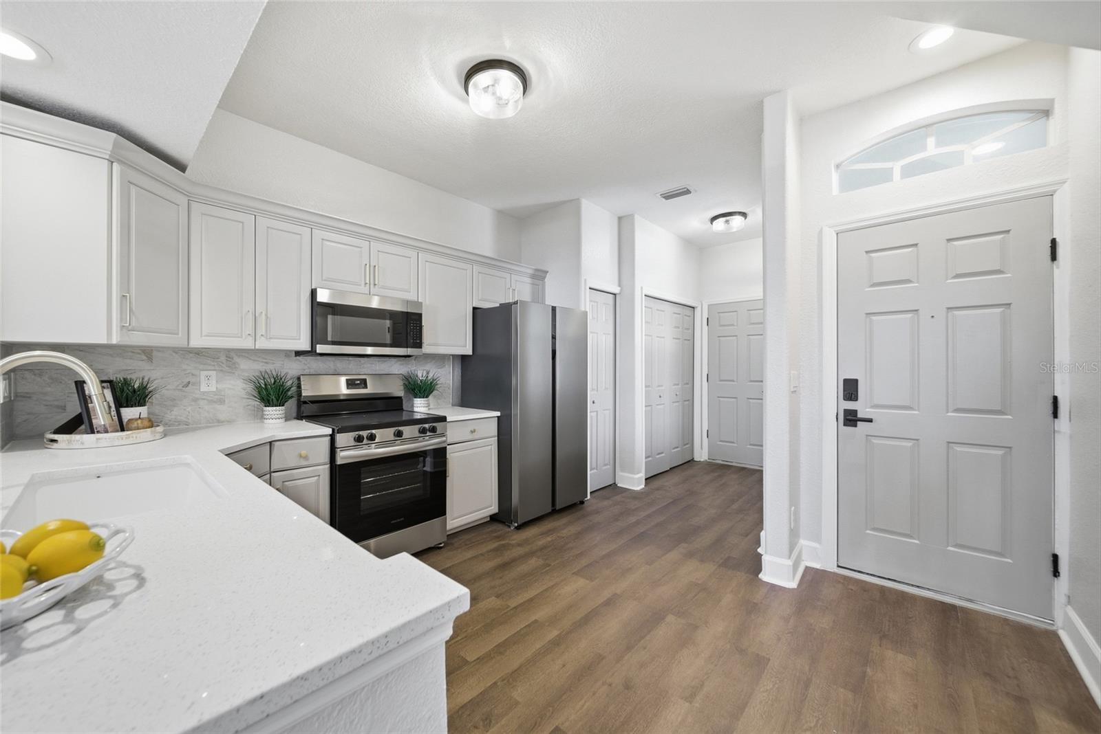 Kitchen view showing door to garage and door to main entrance.