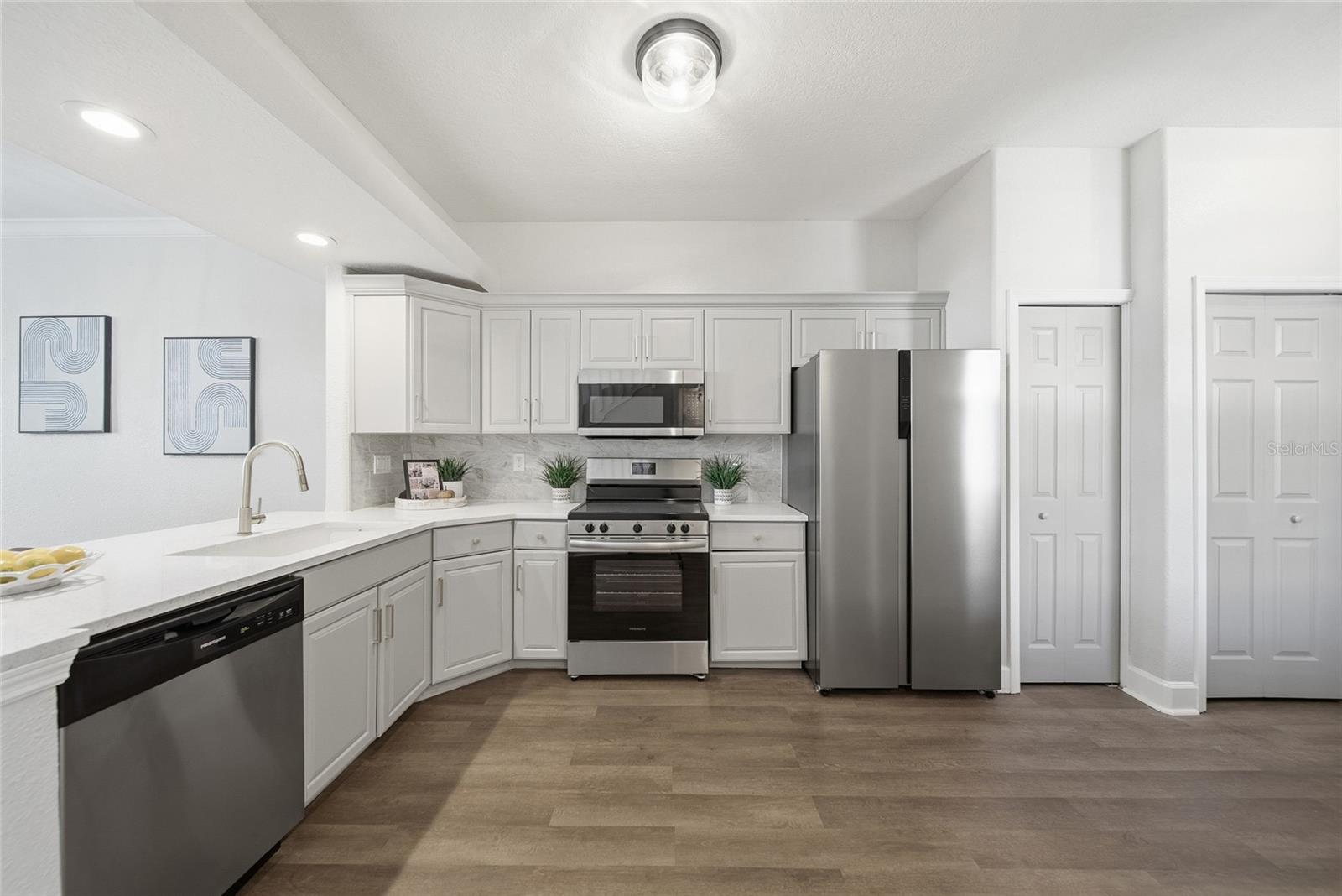 Kitchen view with pantry and laundry room to right.