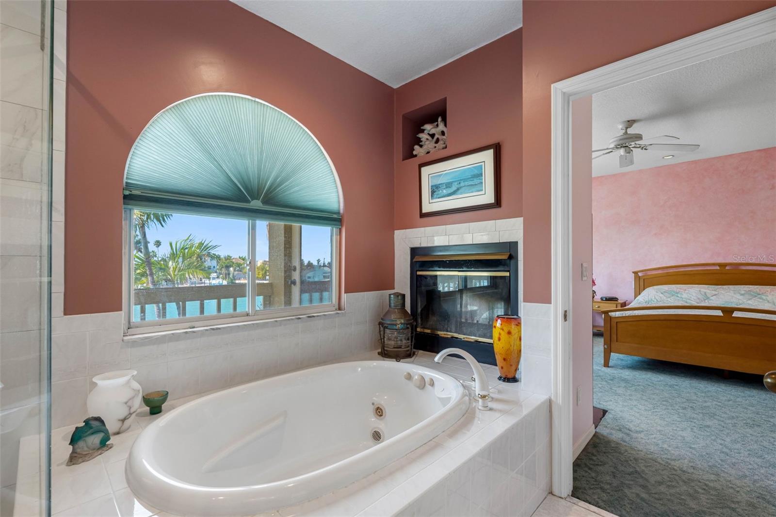 Primary bathroom with jetted tub and wood burning fireplace.