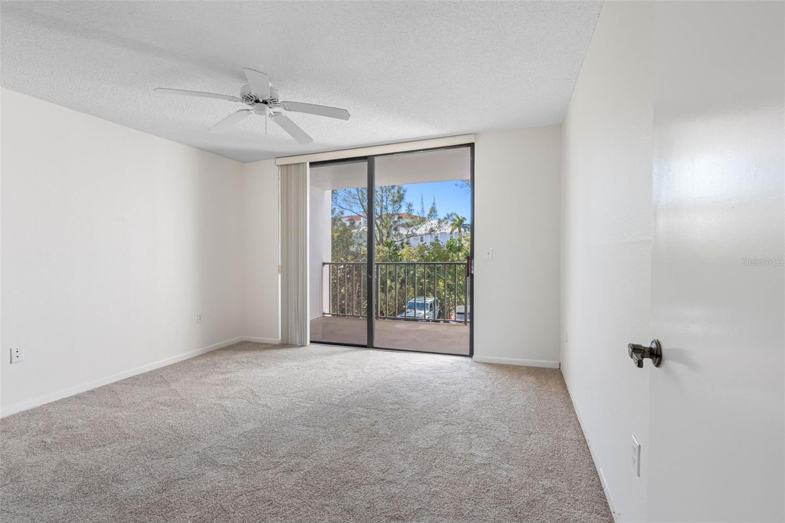 .. Large Guest Bedroom 13 X 12.10... New Paint - New Carpet - Balcony Access. Looking In from Hallway..