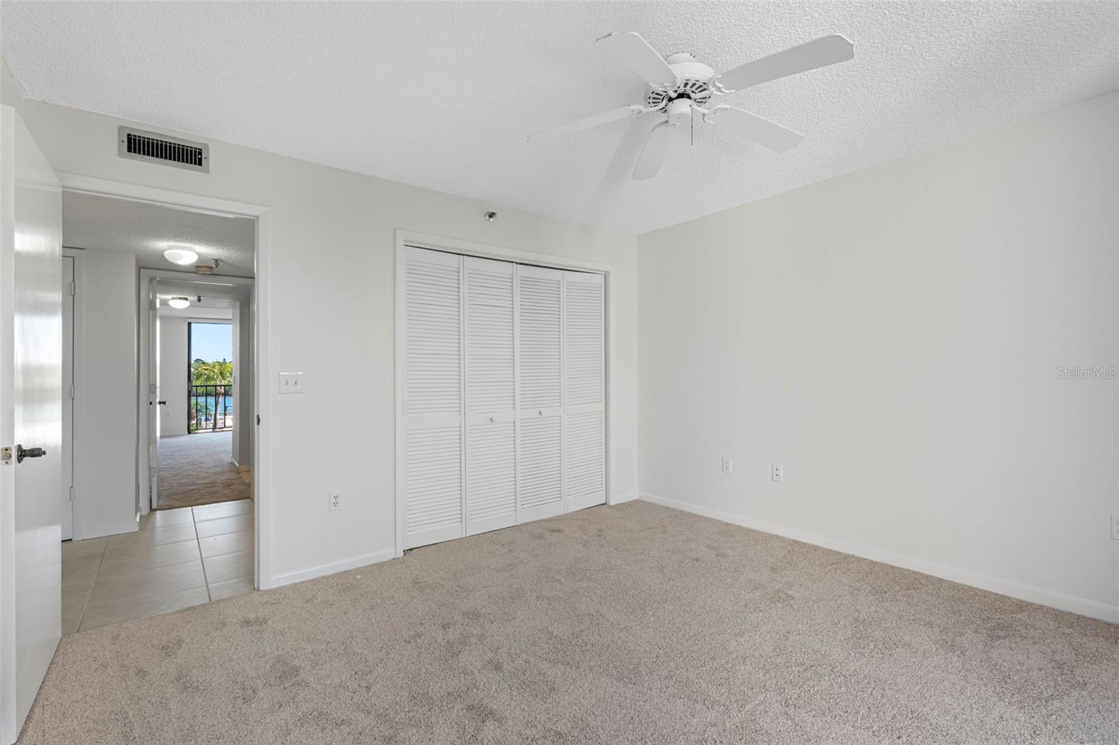 .. Spacious 13 X 12.10 Guest Bedroom..  Looking In From 18' West side Balcony..  Hallway Bathroom #2 Right Outside Bedroom Door.