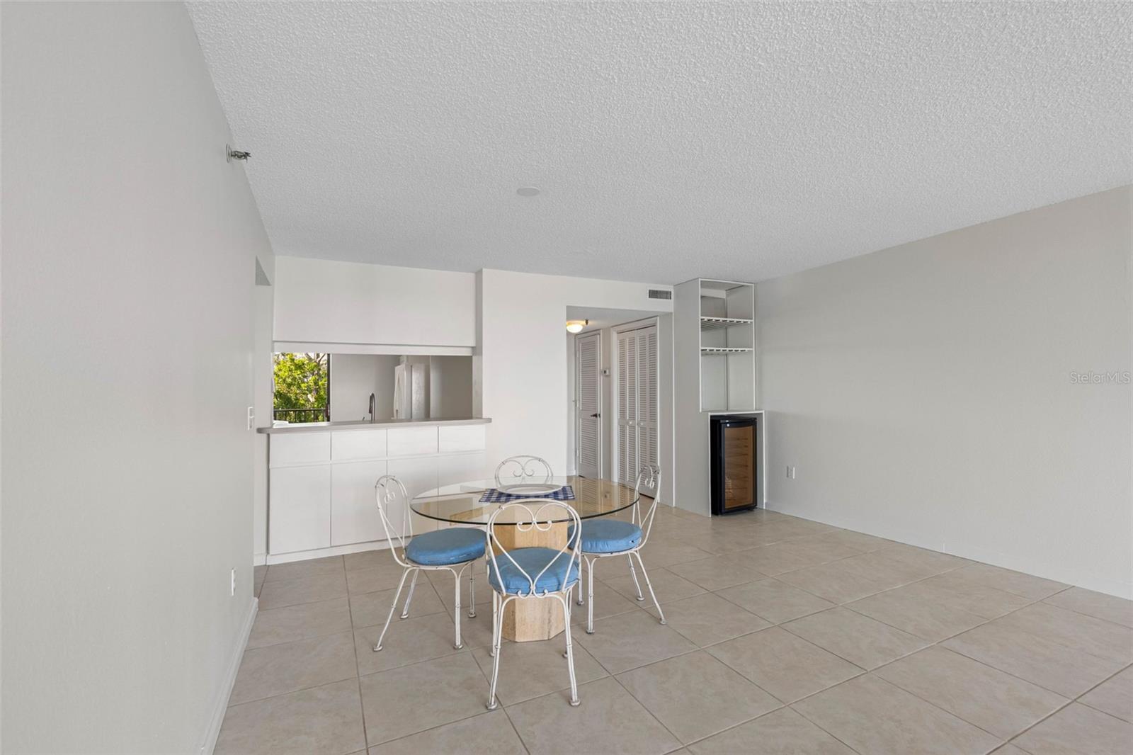 ..Dining Area off Kitchen.. The Spacing from the Kitchen to the Balcony Doors is a good 26 Foot run..Wine Fridge on Right.