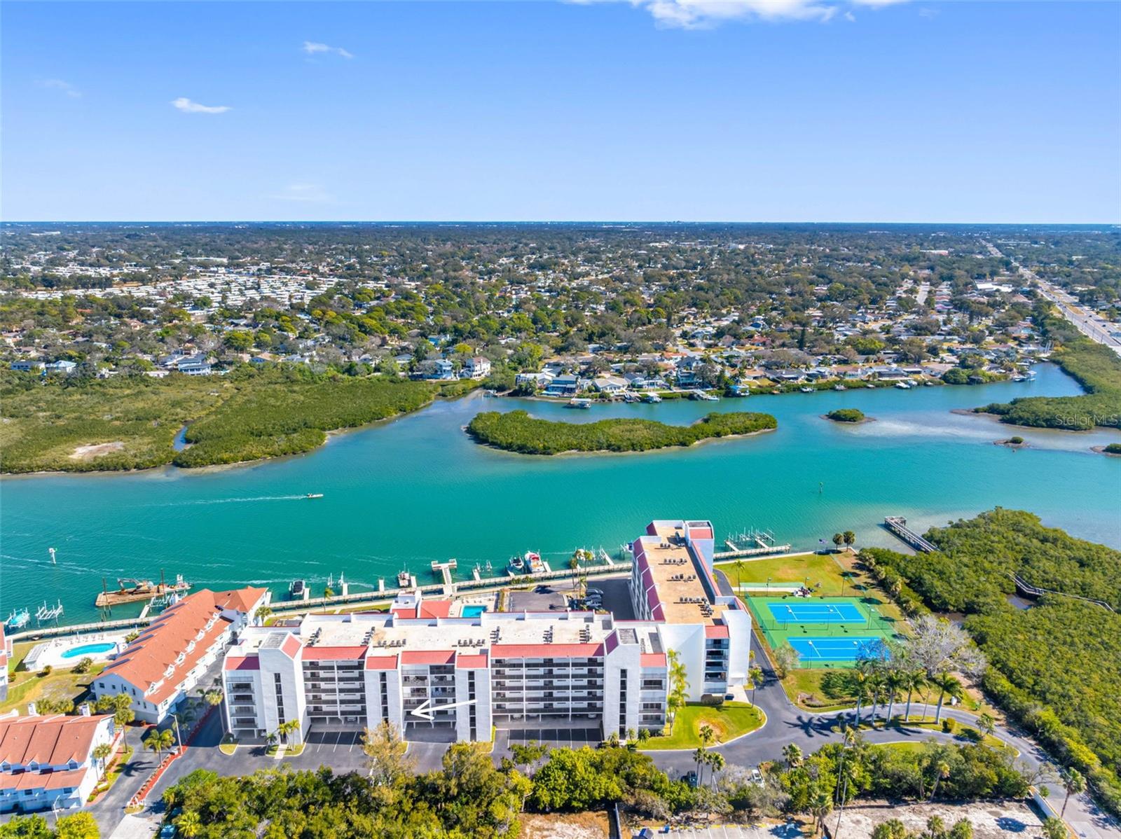.. Aerial Of Intracoastal Waterway Looking Inland.. The Passing Boating Activity is a joy to watch.. The Aquatic Life is amazing and You can have a front row row seat.. To the right or south is a state owned protected area which can never be built on.. The Vista Bay Tennis & Pickle Ball Courts separate the protected area from the main Complex.