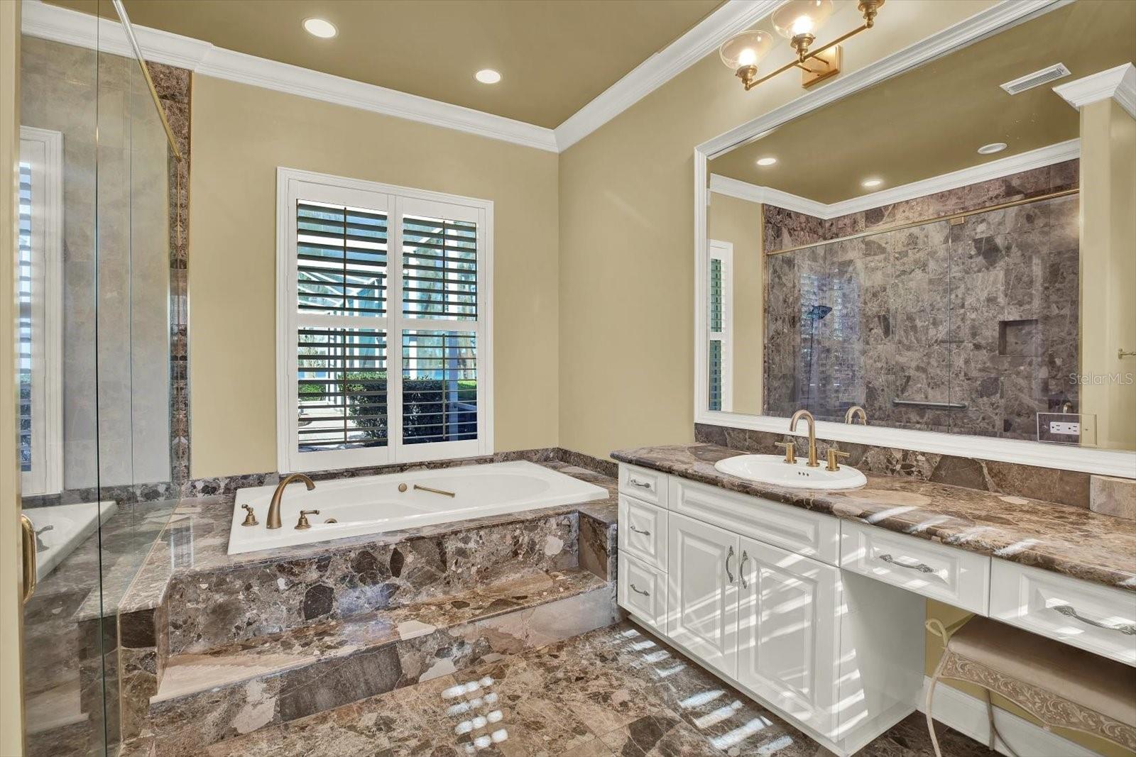 The primary bathroom is filled with natural light.