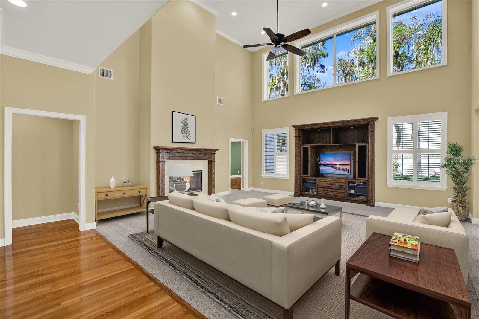 Family room with a cozy fireplace, loads of natural light, and a built in TV console.