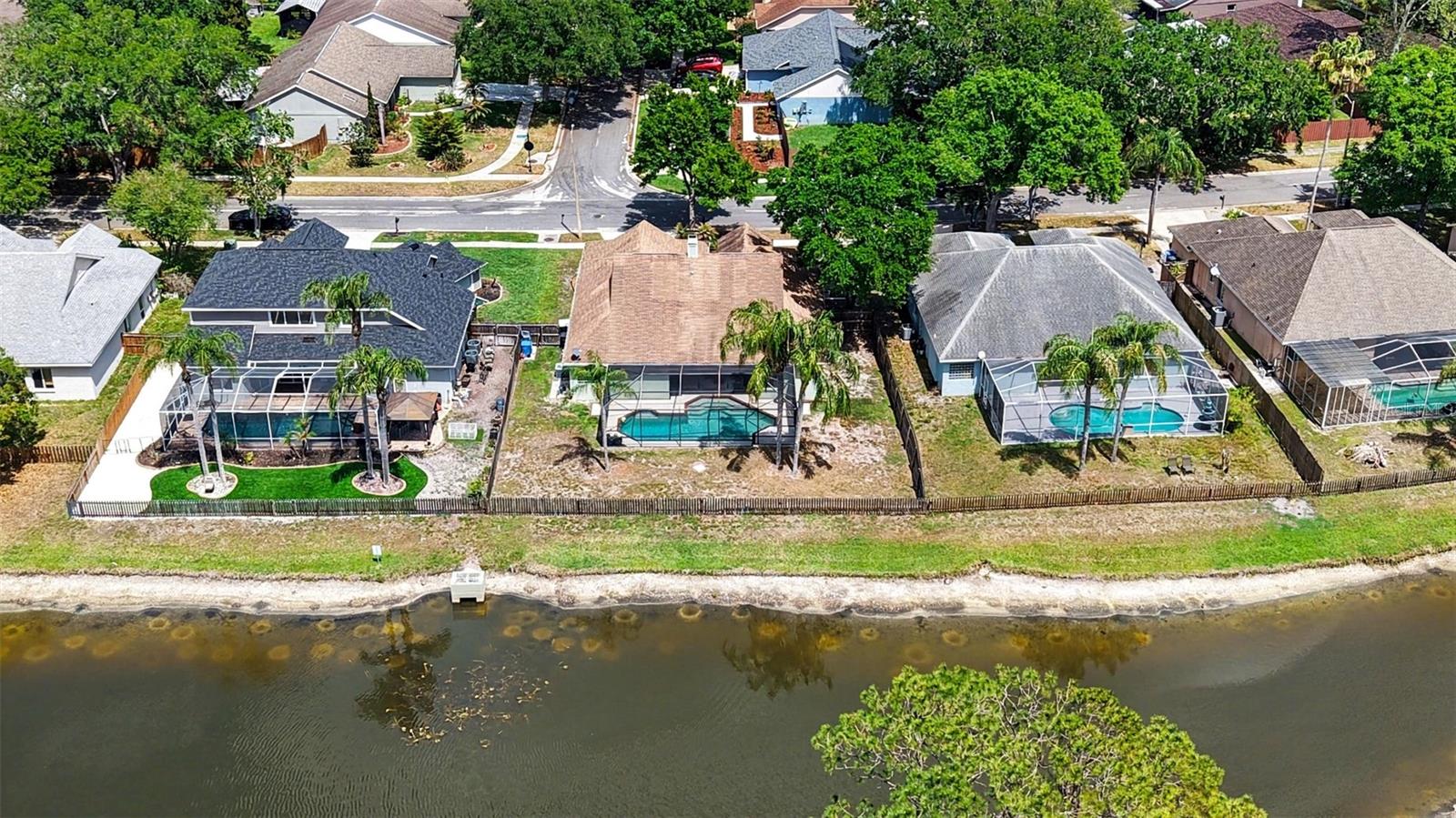 This home backs up to the large pond where you can sit and enjoy the Florida wildlife from the safety of your screen enclosed pool area