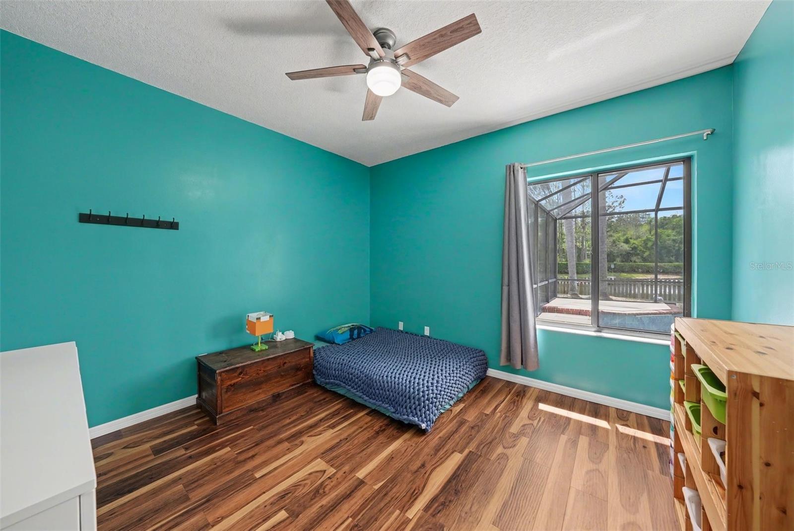 The second bedroom is spacious and also features a walk-in closet