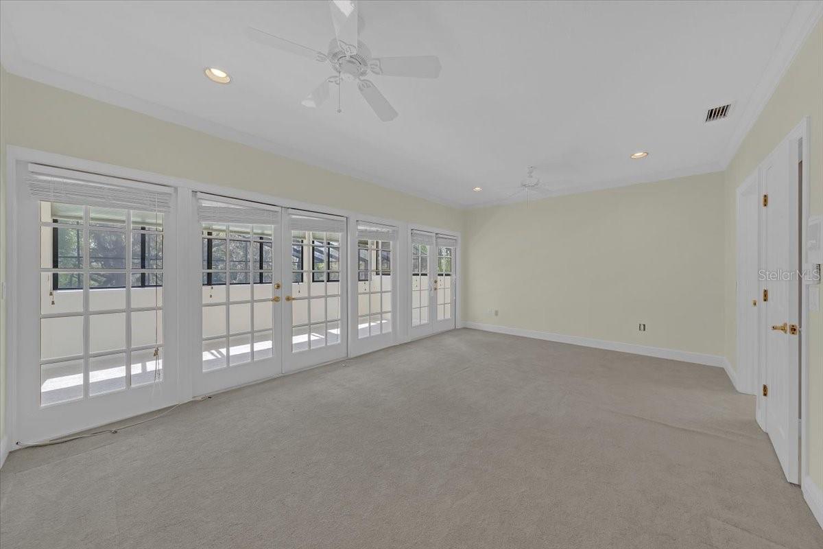 Bedroom 3 with a wall of French doors.