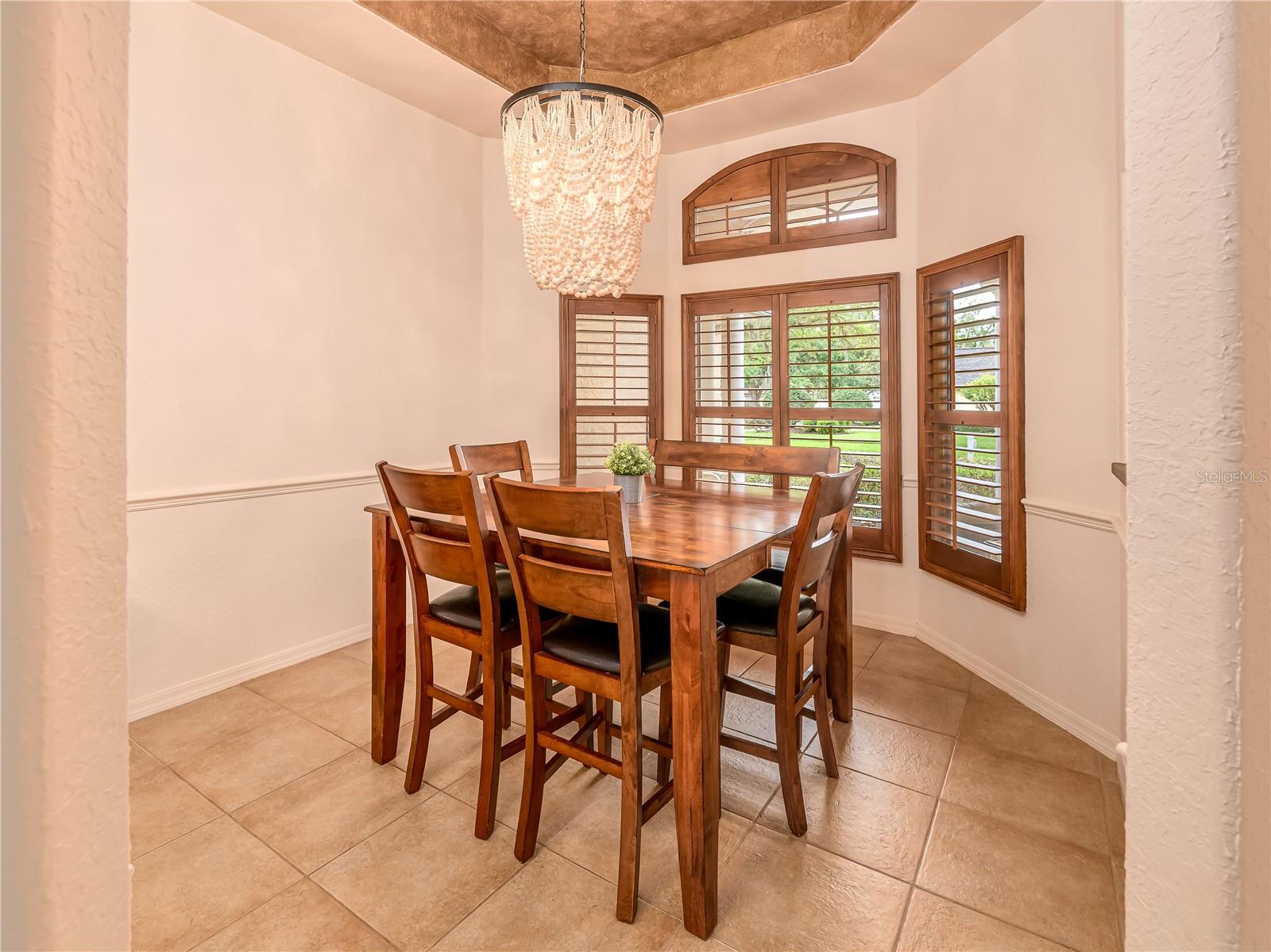 Dining room with tray ceiling, chair rail, & crown moulding