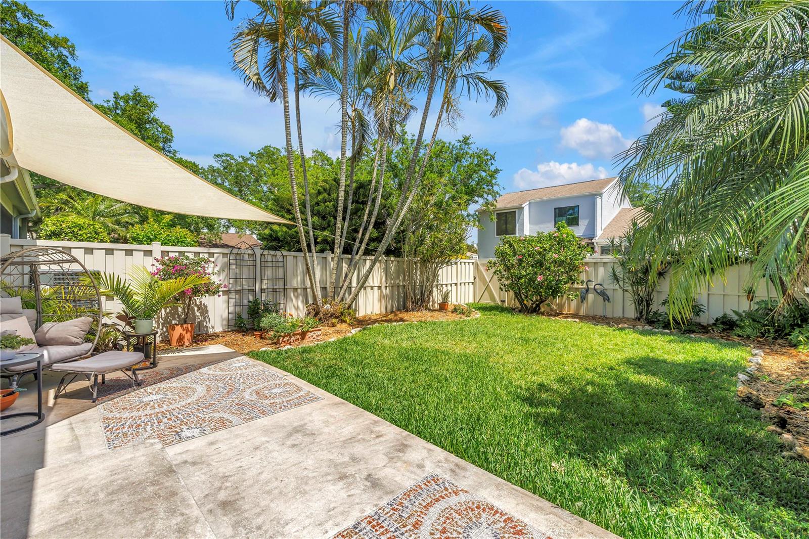 Nicely Manicured Beds and Space.  Areas to sit on the Patio.  Make it your own.  Add a pool, screened Porch or Awning.  All acceptable w/ HOA