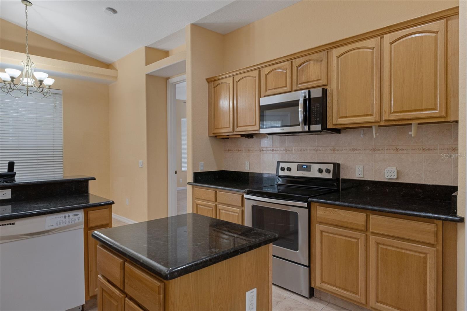 There is an abundance of beautiful solid wood oak cabinets and an island