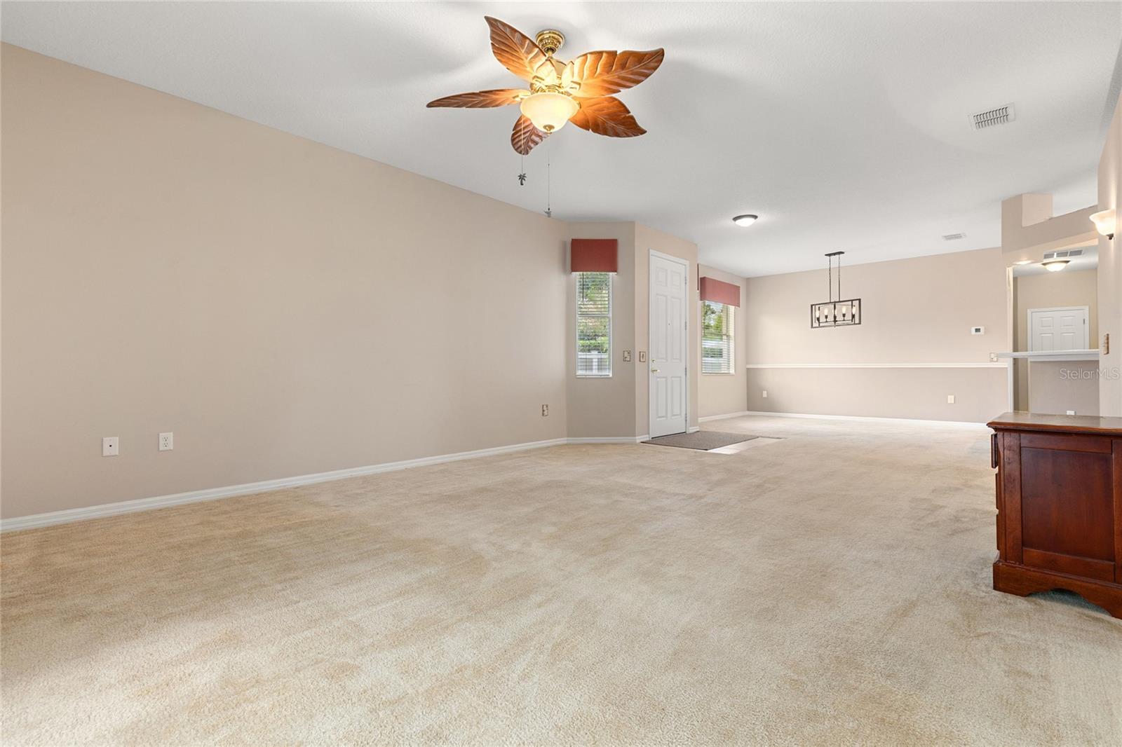 VIEW OF LIVING ROOM AND DINING ROOM FROM SLIDING GLASS DOORS