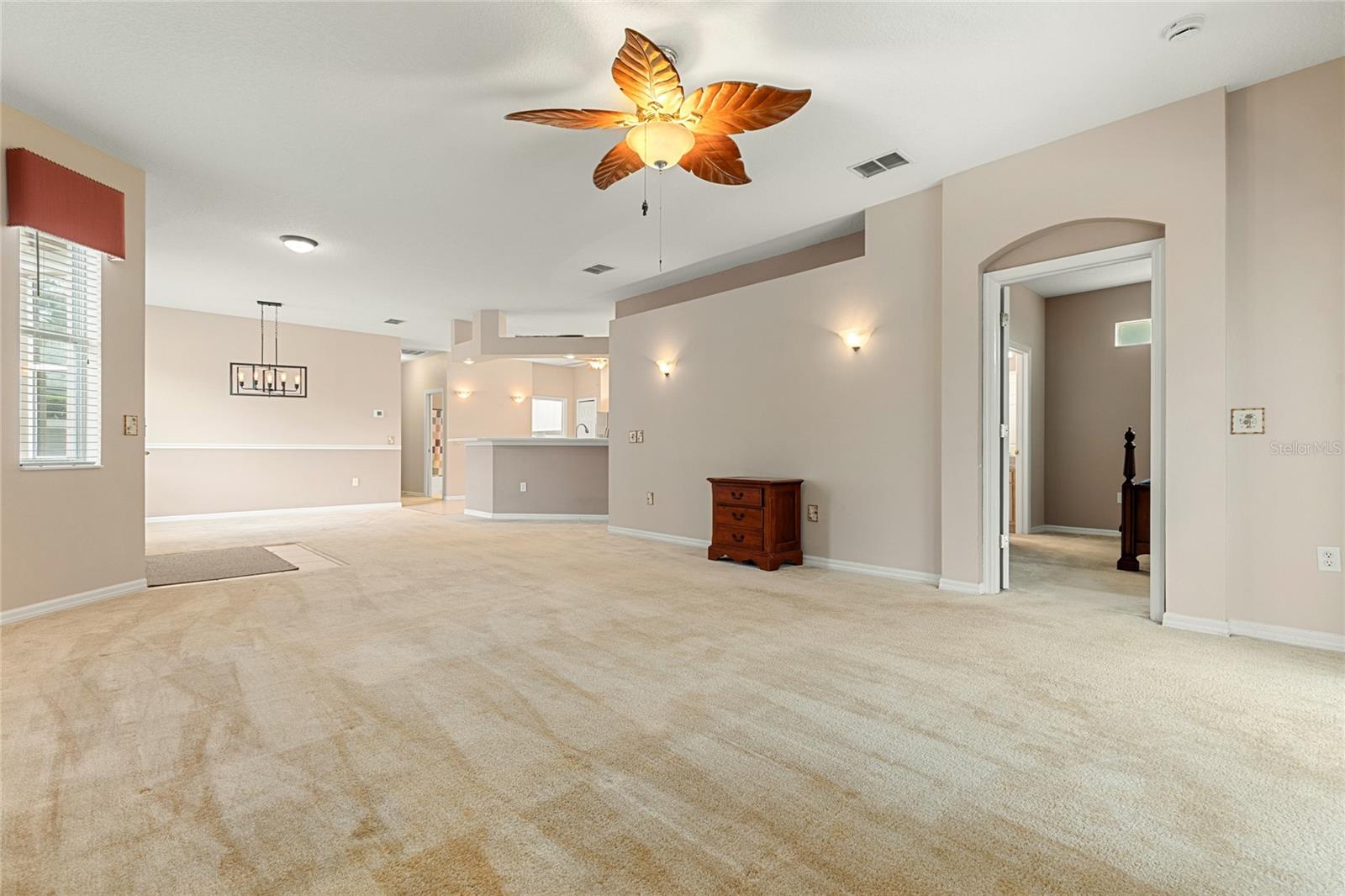 LIVING ROOM SHOWING ENTRANCE TO PRIMARY SUITE