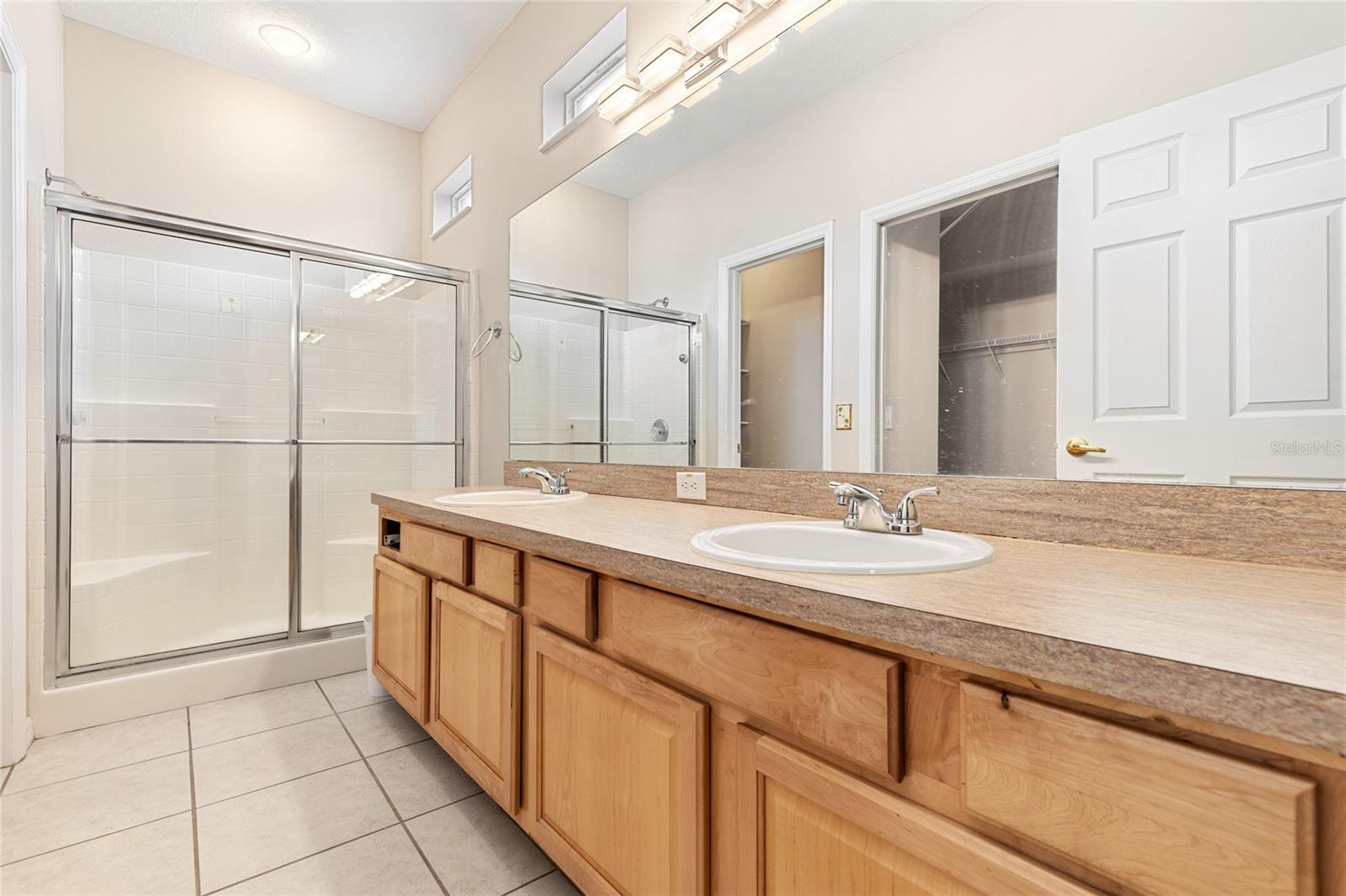 PRIMARY BATHROOM WITH WALK-IN SHOWER AND DOUBLE SINKS