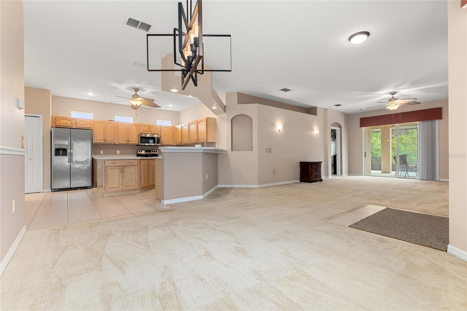 VIEW OF KITCHEN AND LIVING ROOM FROM DINING ROOM