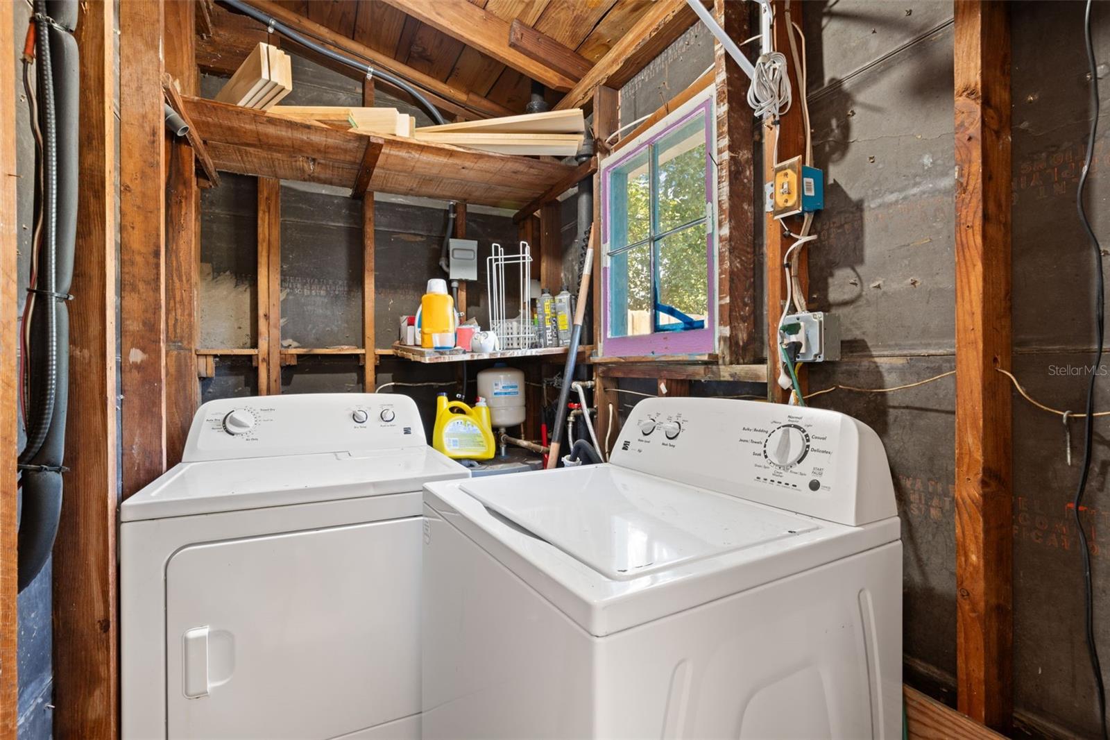 Laundry room with washer and dryer hookups in carport (washer and dryer do not convey).