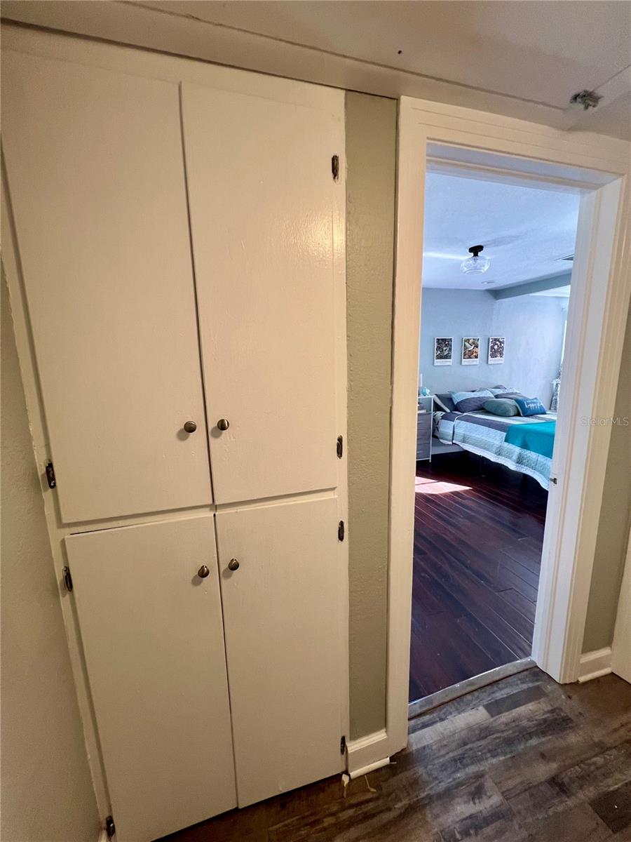 The original built-in storage cabinet in the hallway is perfect for your linens and towels.