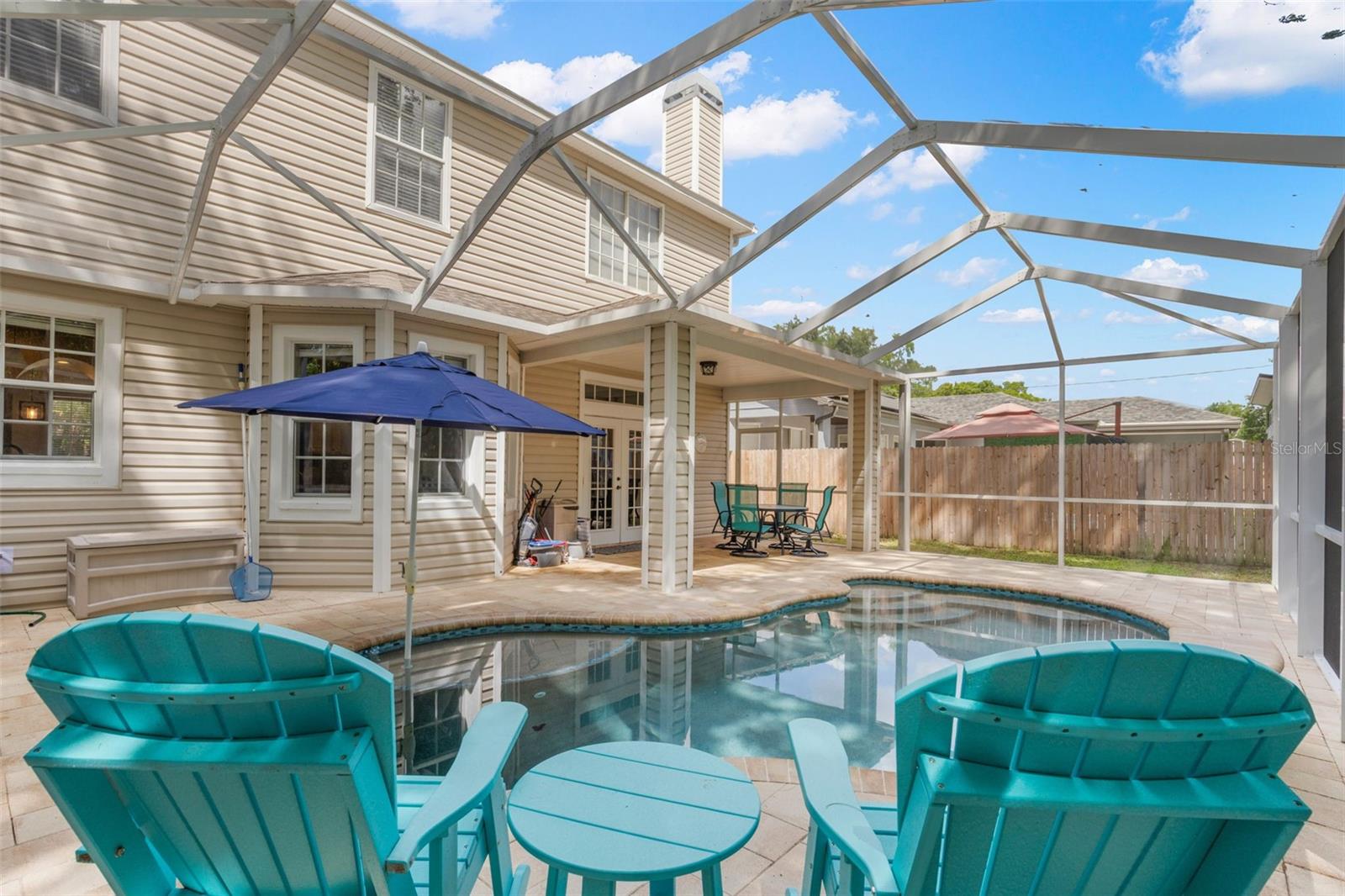 The screened lanai keeps the space clean and usable year-round, while the covered patio is perfect for outdoor dining.